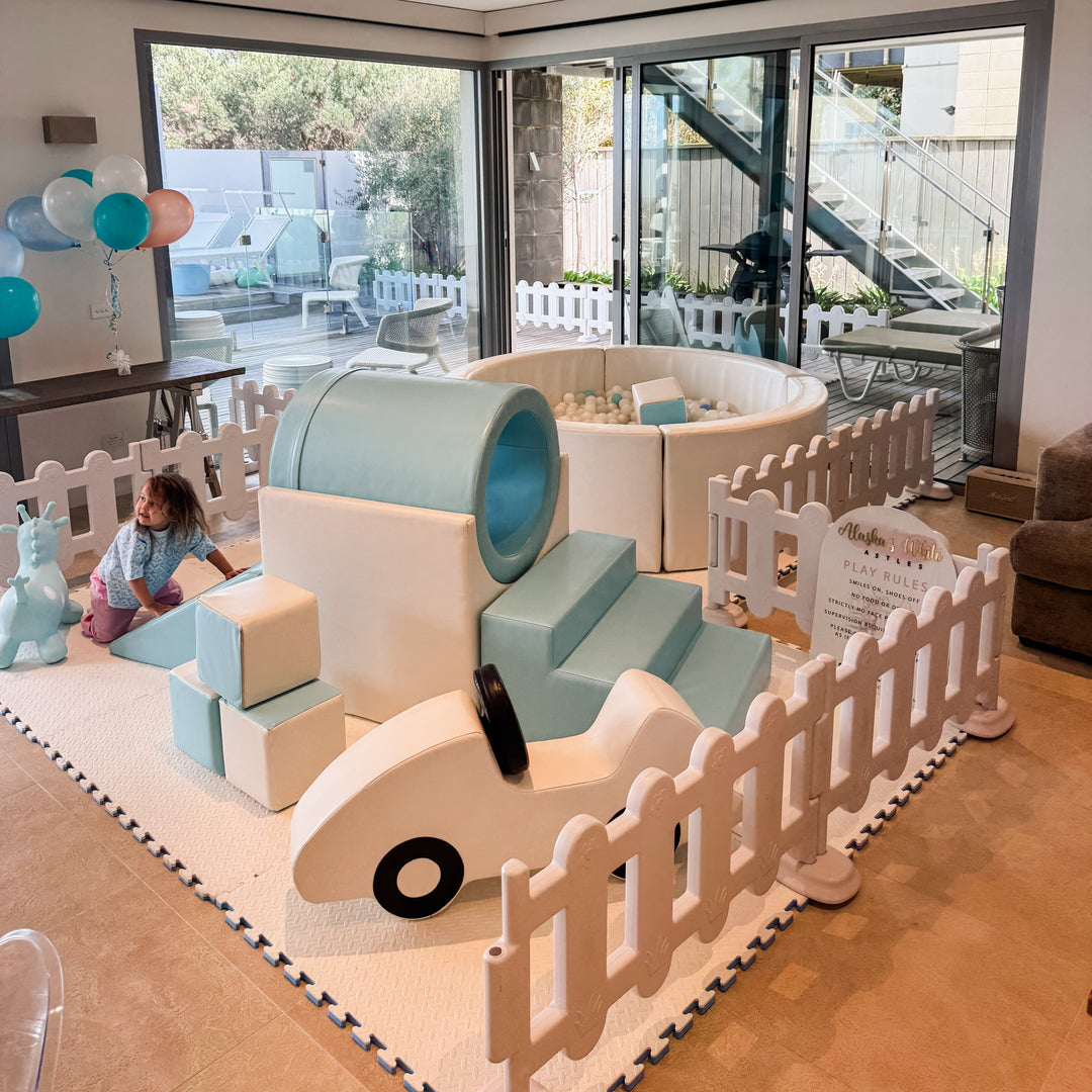 Baby blue soft play package with tunnel climber, car rocker, blocks and ball pit in a living room for party hire in Melbourne