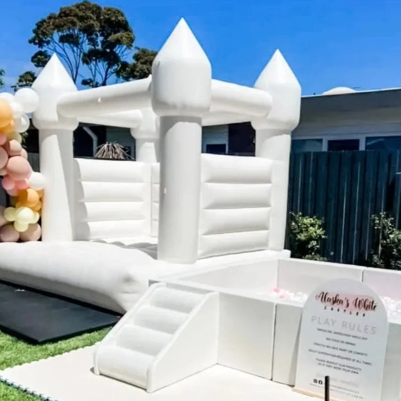 Enchanted Set white castle with peach and pink balloons and a white ball pit with steps on a lawn for party hire in Melbourne