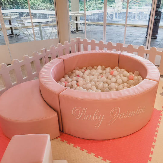 Poppy pink luxe ball pit with a Baby Jasmine name decal, pearl white balls and pink picket fence for party hire in Melbourne