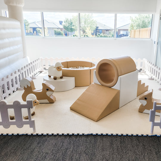 Classic tan soft play package with ball pit, tunnel slide and fox rockers in a white picket fence for party hire in Melbourne