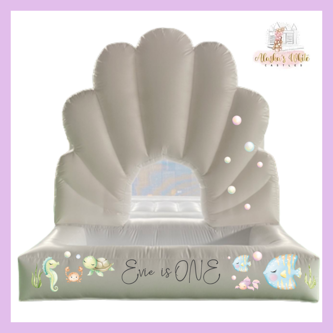 Mockup of under the sea decals on a shell shaped white castle with bubbles, a seahorse, turtle and fish by an Evie is ONE decal