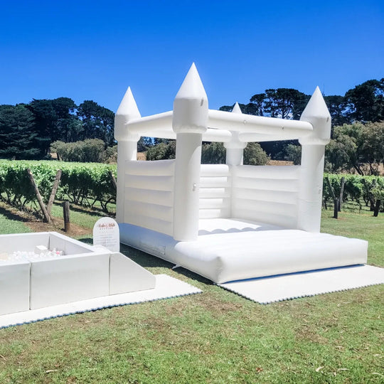 White Sparkle Set with Alaska white bouncy castle and ball pit on a lawn beside vineyard rows for party hire in Melbourne